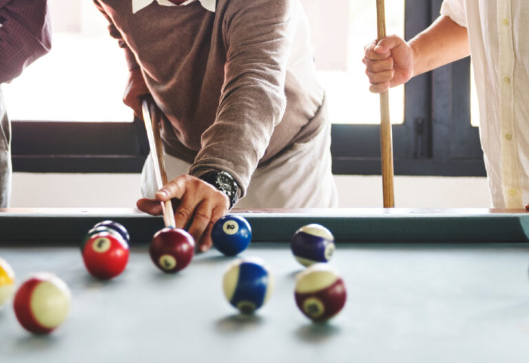 Drive Workforce Lodging team playing pool.
